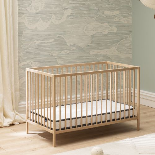 Lit en bois clair équipé du matelas bébé en mousse ferme Bultex Tichou.