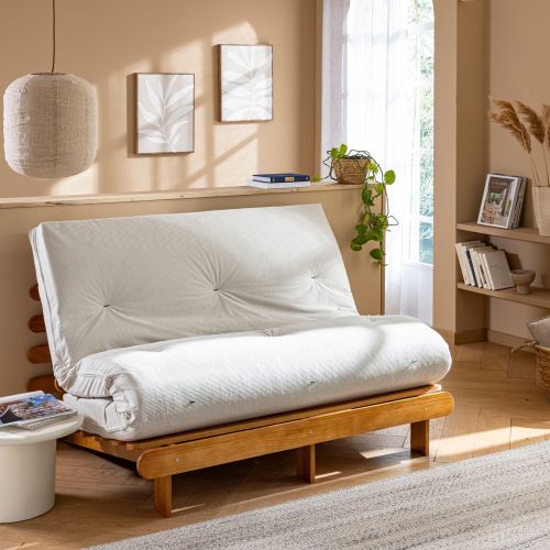 Matelas futon mémoire de forme tissu velours Terre de Nuit écru plié en canapé.
