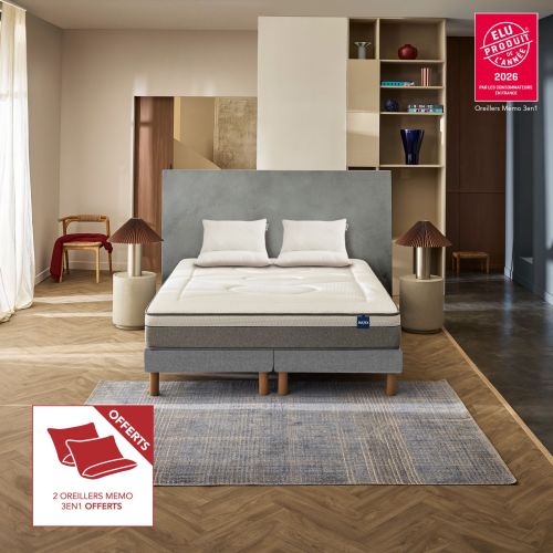 Ensemble matelas hybride Bultex Restore dans une chambre moderne avec 2 oreillers 60x60 cm offerts.