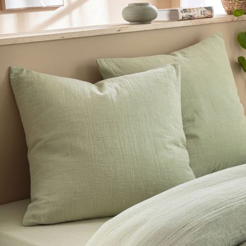 Harmonie de couleurs sur un lit avec taie oreiller gaze de coton vert sans repassage