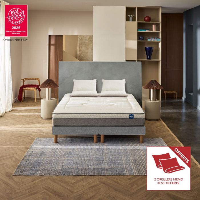 Ensemble matelas hybride Bultex Restore dans une chambre moderne avec 2 oreillers 60x60 cm offerts.
