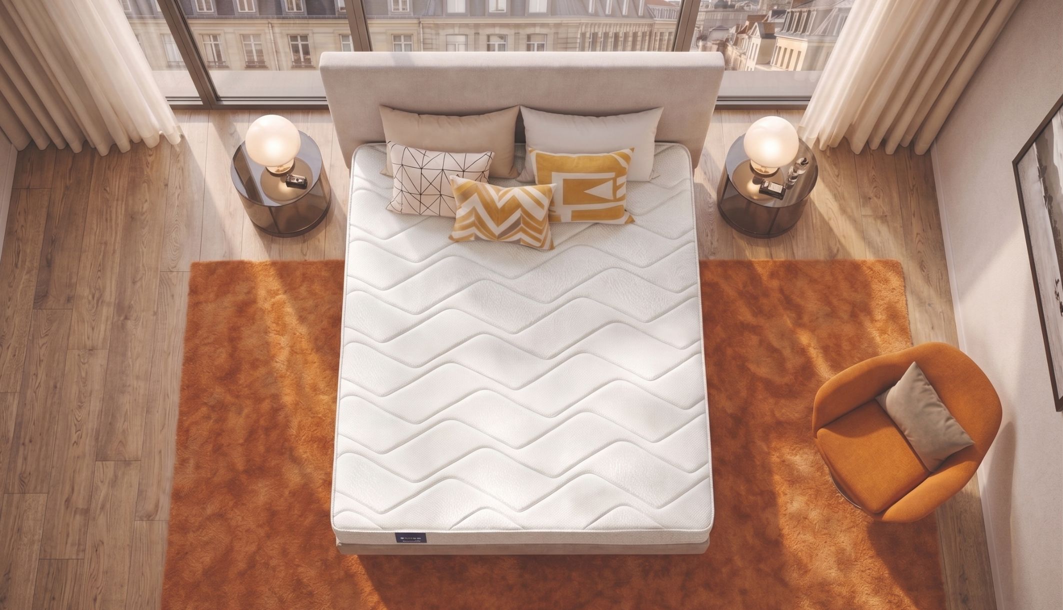 Vue de dessus du matelas ferme Dunlopillo Jonquille 2 dans une chambre avec tapis orange.