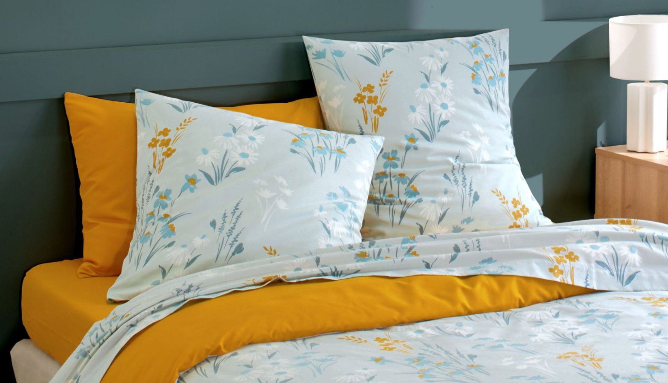 Linge de lit respirant aux imprimés botaniques dans une chambre lumineuse