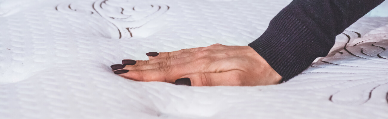 main de femme sur surface matelas